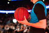 referee holding basketball during game