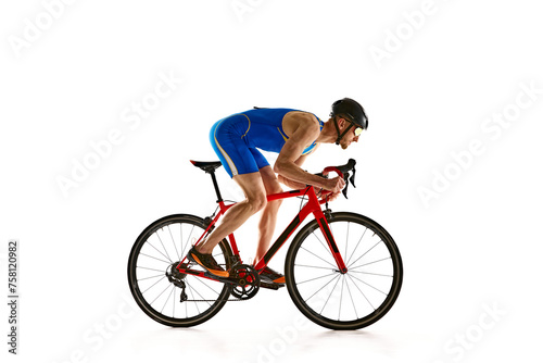 Concentrated and motivated man in sportswear and helmet, bicyclist in motion, training isolated on white studio background. Concept of sport, active and healthy lifestyle, speed, endurance, hobby