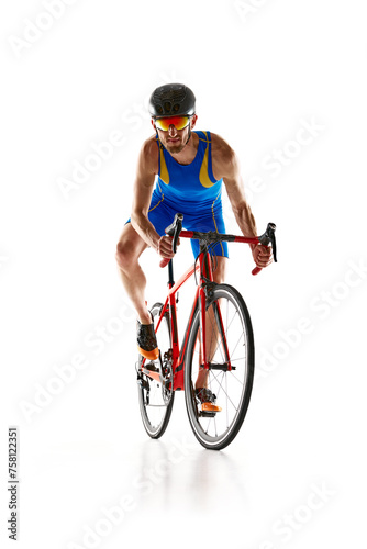 Fototapeta Naklejka Na Ścianę i Meble -  Front view image of man, athlete in blue sportswear helmet and goggles in motion training on bike isolated on white studio background. Concept of sport, active and healthy lifestyle, speed, endurance