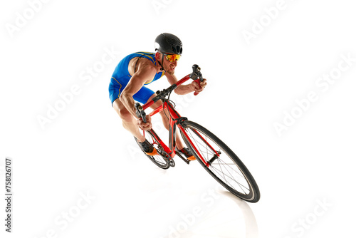Fototapeta Naklejka Na Ścianę i Meble -  Dynamic image of concentrated man, athlete, cyclist on motion riding on bike isolated on white studio background. Concept of sport, active and healthy lifestyle, speed, endurance, hobby
