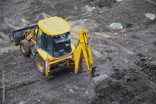 Yellow excavator on a construction site,