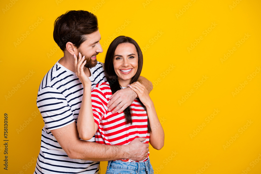 Naklejka premium Photo portrait of nice young couple hugging sweet relationship wear trendy striped outfit isolated on yellow color background