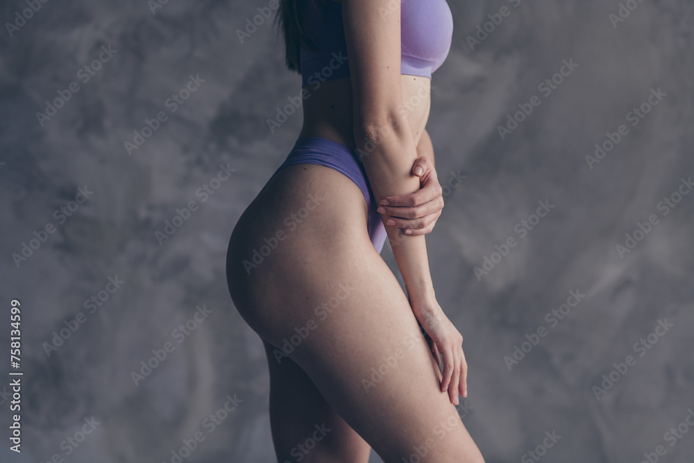 No filter cropped photo of elastic booty abs gym exercises and anti cellulite complex effect isolated on grey concrete wall background - obrazy, fototapety, plakaty 