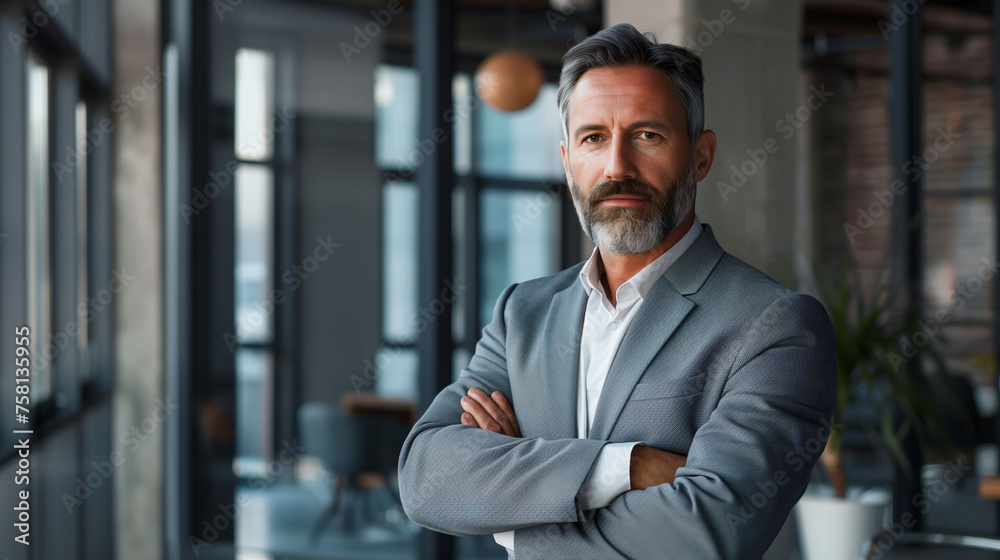 Confident senior professional in elegant suit inside office