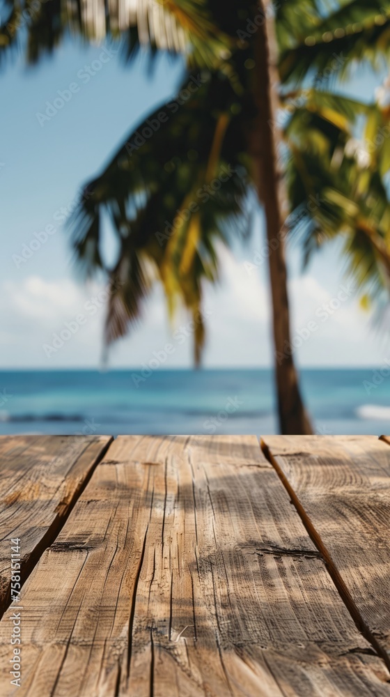 Empty wooden planks table against a blurred background with a sea coast with palm trees during the day