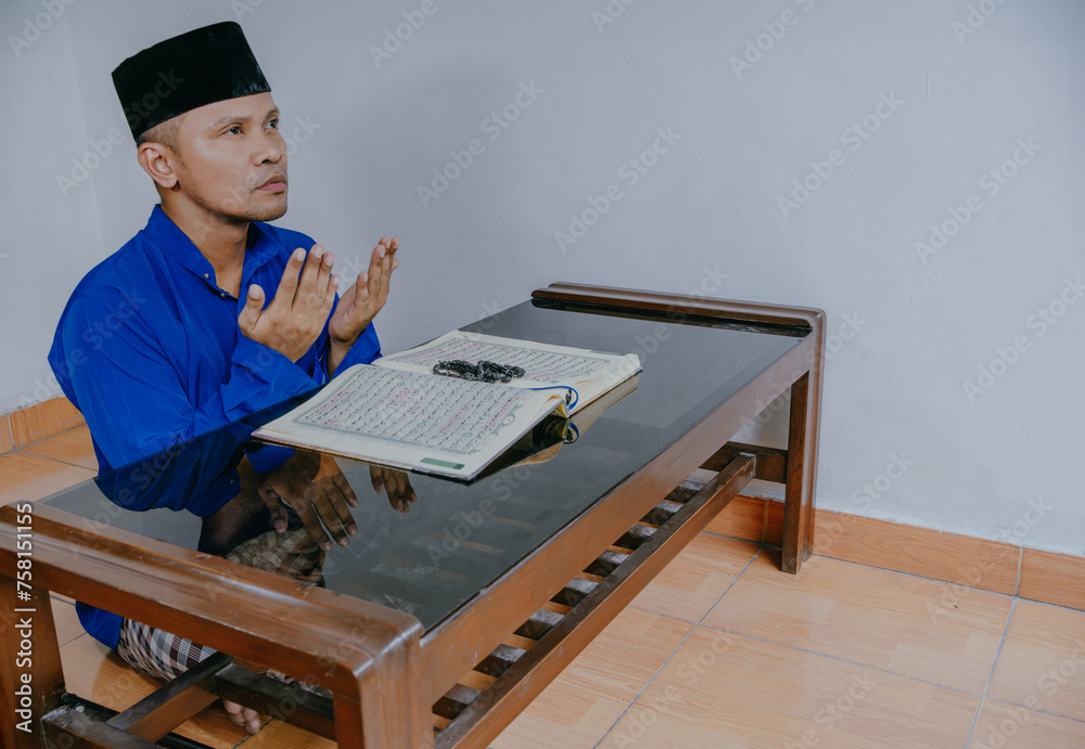 Religious muslim man praying inside the mosque. Religious muslim man praying inside the mosque.