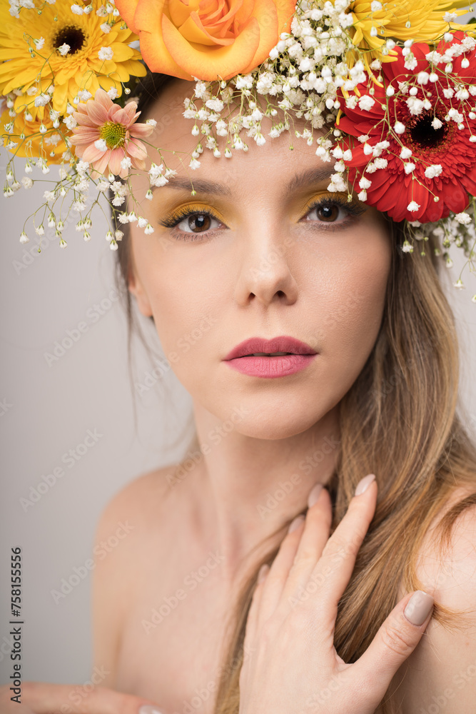 A close-up portrait of a woman, her face partly veiled by a magnificent floral crown that radiates nature's vibrant essence. Her touching gesture adds a hint of tenderness.