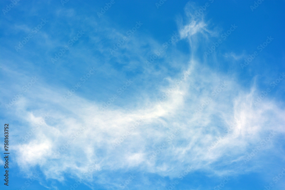 Beautiful and unusual nature, bright light blue sky with small white clouds.