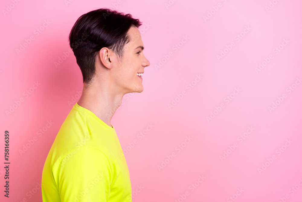 Photo portrait of handsome teen male profile empty space toothy smile dressed stylish yellow garment isolated on pink color background Photo portrait of handsome teen male profile empty space toothy smile dressed stylish yellow garment isolated on pink color background