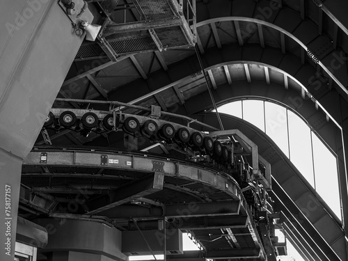 wheels pressing down the suspension system of the cab at the cable car station - black and white photo