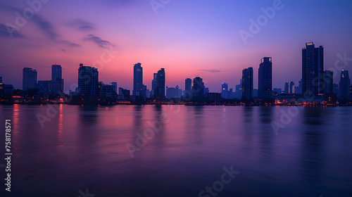A photo of the Bangkok skyline, with the Chao Phraya River in the foreground, during twilight
