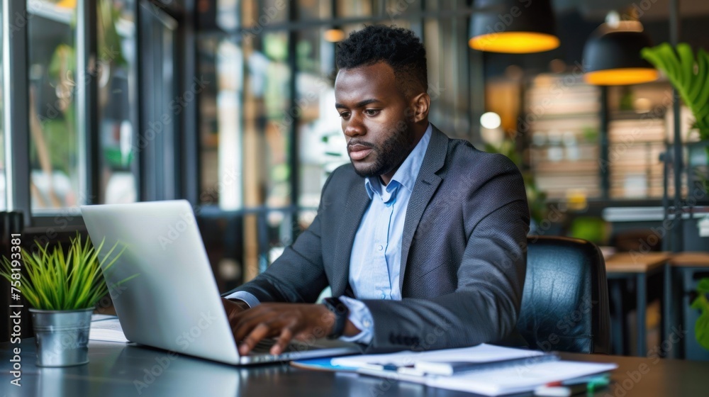 handsome businessman using a laptop to work on a new business project on the table in the office handsome businessman using a laptop to work on a new business project on the table in the office