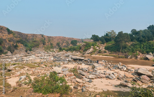 flow of Telwa river stream falling through levels of rocky terrain at Dharhara falls in Simultala, Bihar. Water level is knee-deep as flow of water is mostly dried-up in winter season. © suprabhat