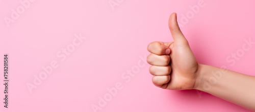 Elegant Woman's Hand Gracefully Holding a Vibrant Pink Paper Sheet