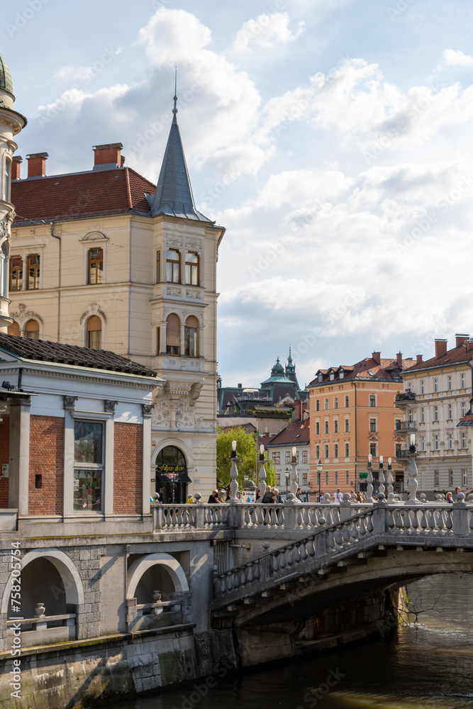 Ljubljana, Slovenia;   triple Bridge Tromostovje and beautiful old building, Ljublianica river.