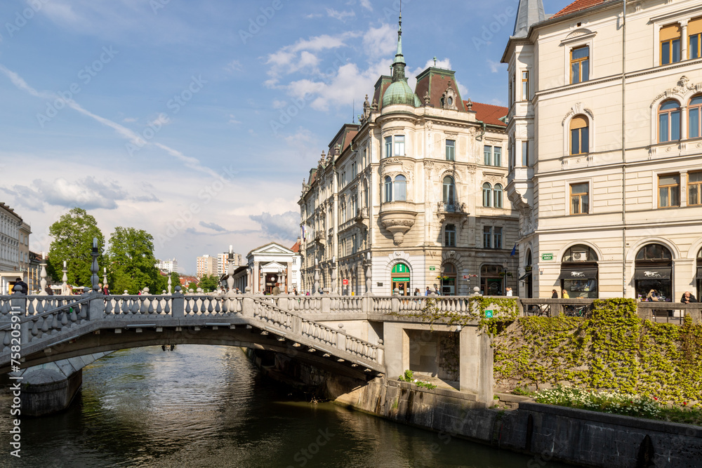 Ljubljana, Slovenia;  triple Bridge Tromostovje and beautiful old building, Ljublianica river.