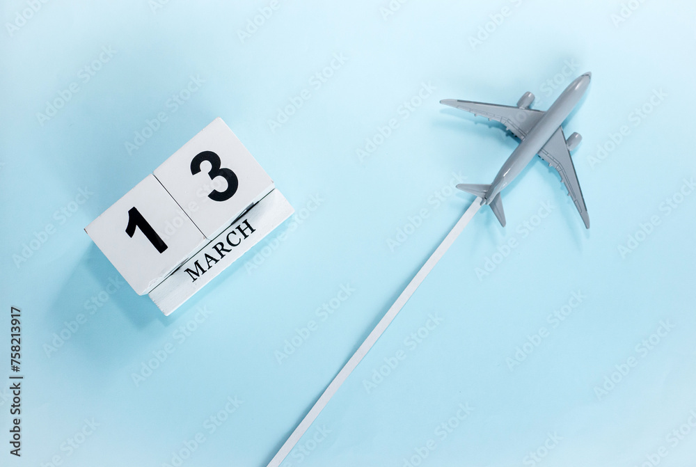 March calendar with number 13. Top view of a calendar with a flying passenger plane. Scheduler. Travel concept. Copy space. March calendar with number 13. Top view of a calendar with a flying passenger plane. Scheduler. Travel concept. Copy space.