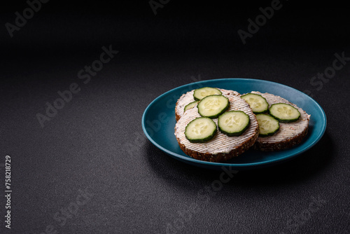 Delicious vegetarian sandwich with grilled toast, cream cheese, cucumbers and seeds