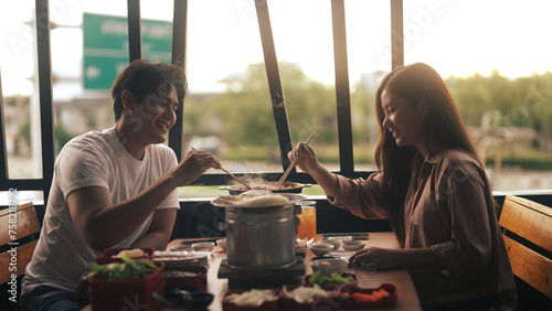 Asian couple eating barbecue in a restaurant © pigprox
