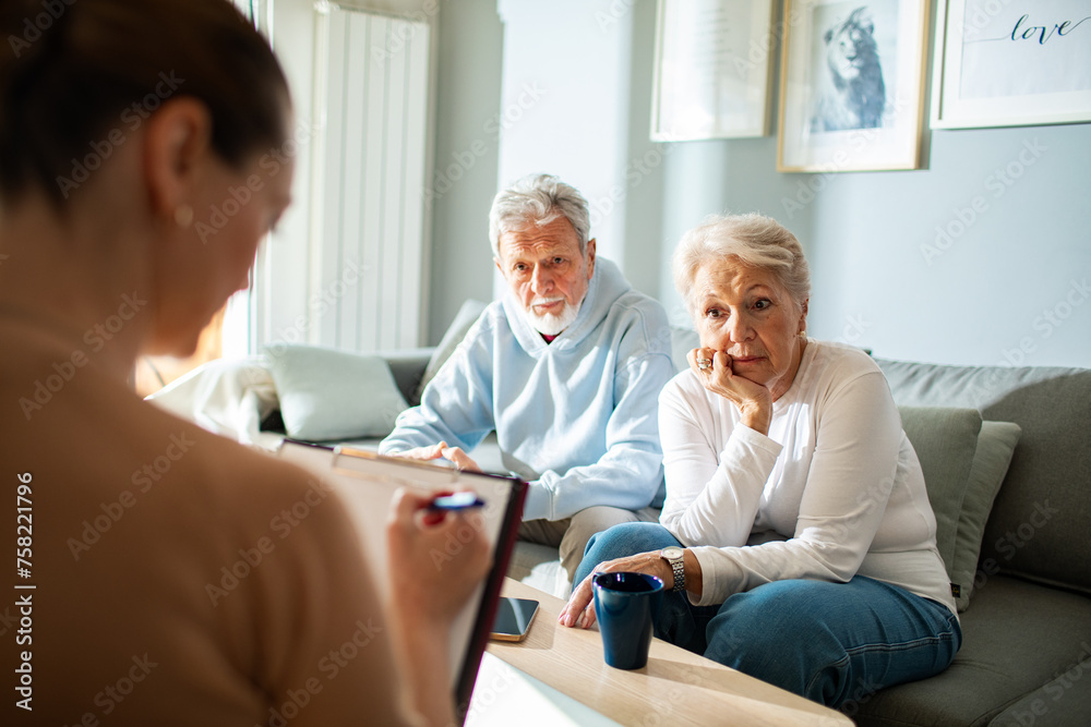 Senior couple in consultation with a professional woman at home Senior couple in consultation with a professional woman at home