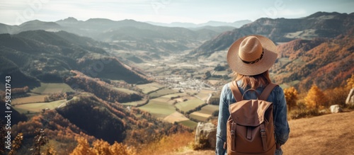 Serene Female Hiker Contemplating Scenic Mountain View with a Backpack