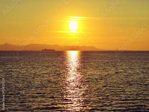 Sunset in Athens with ship passing by