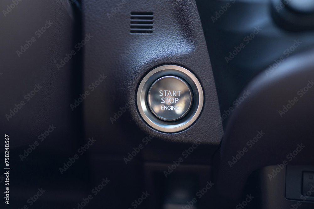 Starting car engine. Button to start the car engine. Pushing start stop