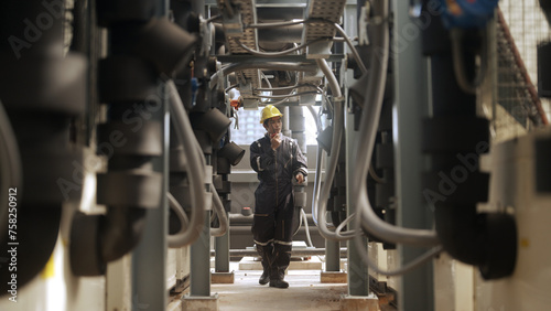 Engineer inspects pipes in a factory © pigprox