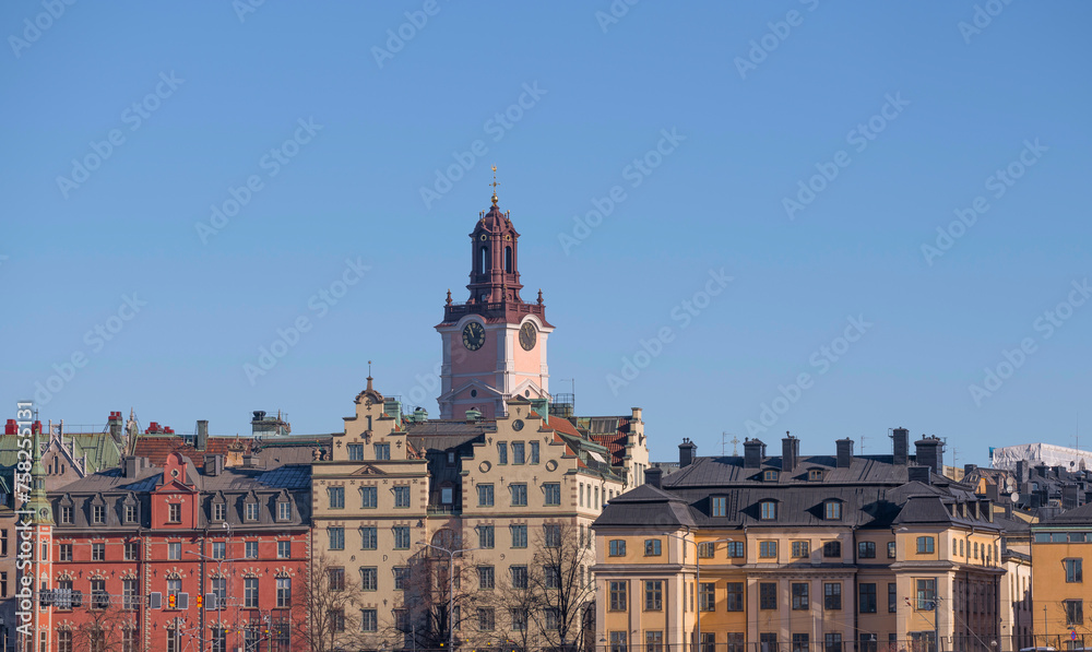 The old town Gamla Stan with 1700s houses and the church tower of Storkyrkan, a sunny winter day in Stockholm