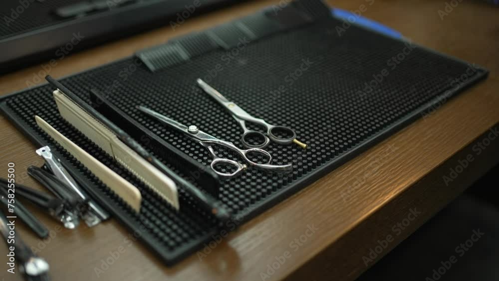 Barber's Precision Tools on Tray. A professional set of barber's tools neatly arranged on a textured tray. Barber's Precision Tools on Tray. A professional set of barber's tools neatly arranged on a textured tray.