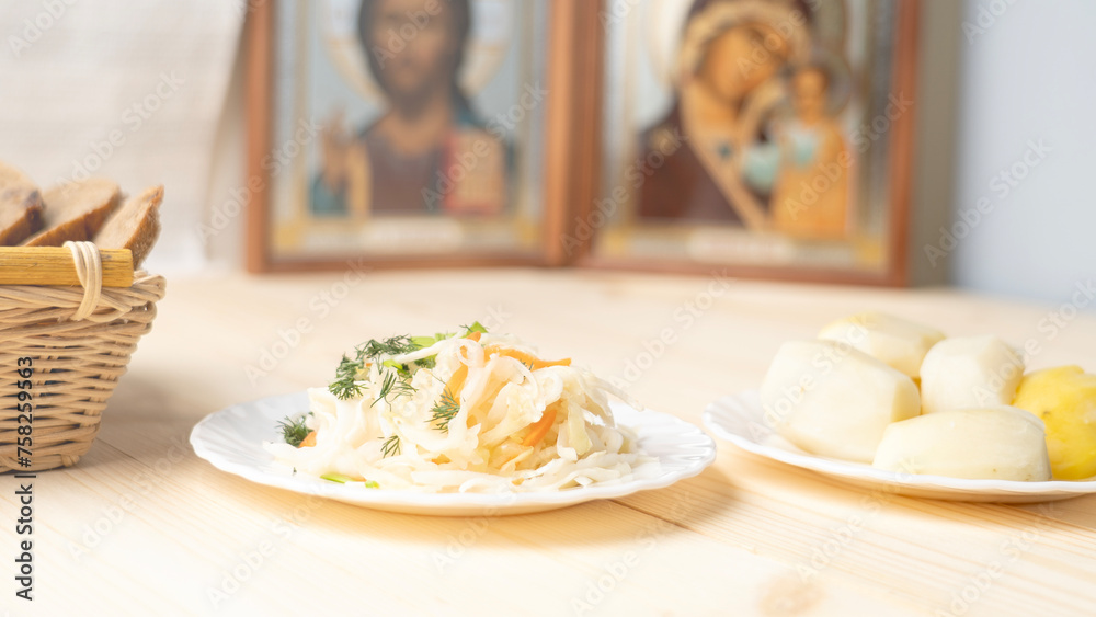 Holy Week, End, Palm Sunday, Good Friday, Easter Sunday Concept. Orthodox food in Great Christian Lent, Lenten food on a wooden table against the background of Orthodox icons. Holy Week, End, Palm Sunday, Good Friday, Easter Sunday Concept. Orthodox food in Great Christian Lent, Lenten food on a wooden table against the background of Orthodox icons.