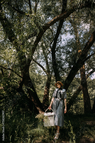 The image shows a person carrying a basket outdoors in a forest setting during the summer. 6333