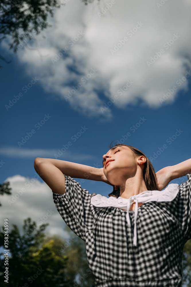 The image shows a person with their arms raised against a sky background. 6386 The image shows a person with their arms raised against a sky background. 6386