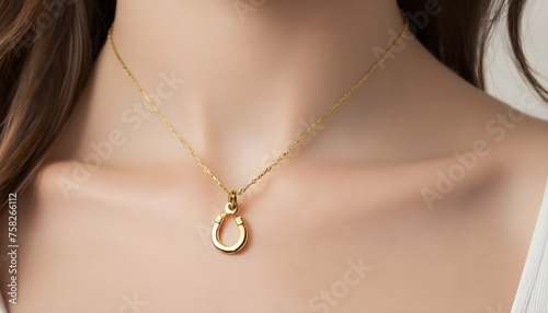 A Delicate Gold Necklace Featuring A Tiny Horsesho