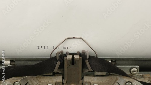 typing a famous catchphrase I'll be back on a vintage typewriter close-up photo