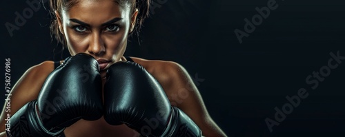 A woman with black boxing gloves