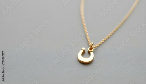 A Delicate Gold Necklace Featuring A Tiny Horsesho