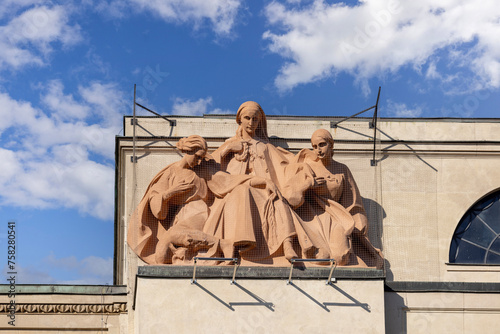 Figures on the top of National Bank of Poland building , allegory of agriculture, Krakow, Poland photo