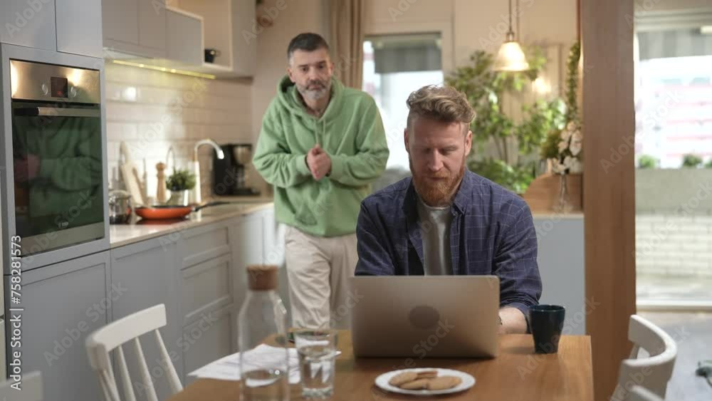 Happy same-sex male couple celebrating moving into a new home with wine Happy same-sex male couple celebrating moving into a new home with wine