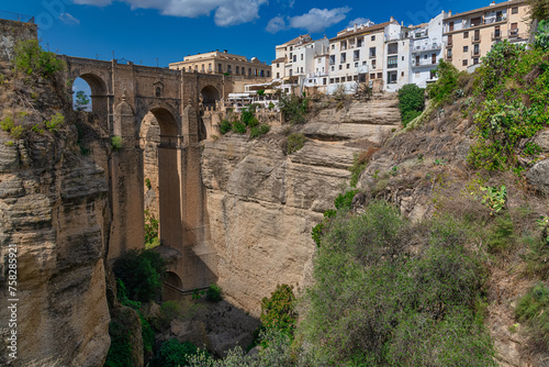 New bridge (Puente Nuevo) and the famous white houses on the cliffs in the city Ronda, Andalusia, Spain. photo