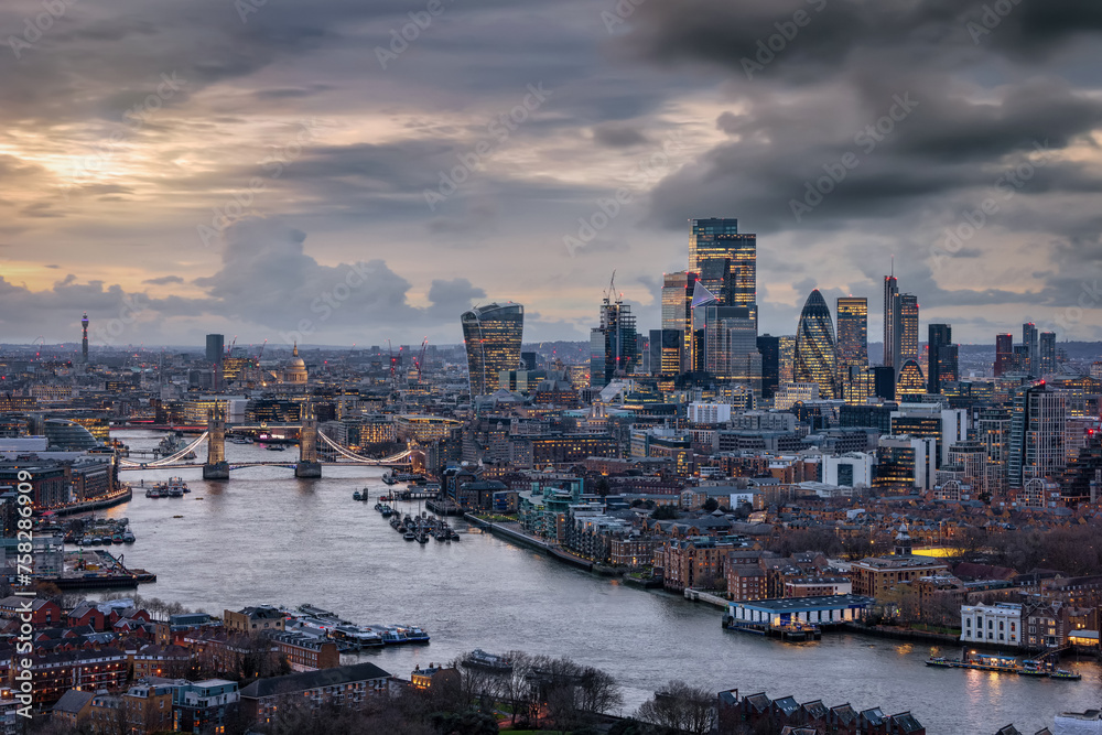 Panoramic view of the 2024 skyline of London with City, Tower Bridge and skyscrapers during a moody evening with clouds
