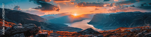 Breathtaking panoramic landscape of a rugged fjord illuminated by a spectacular sunset, suggesting vastness and awe