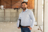 A confident construction manager poses for a portrait, embodying professionalism, experience, and the ability to successfully navigate complex construction projects. 