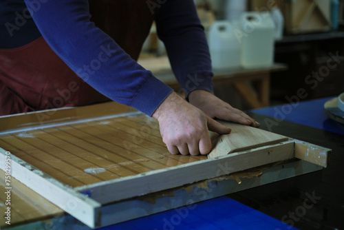 Preparing for the resin pour, an artisan aligns the wood. This step is crucial for achieving a perfect fusion of materials.