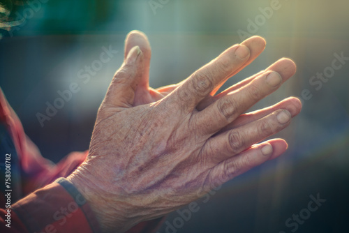 Old person hands put together in prayer gesture. Closeup, shallow DOF. © logoboom