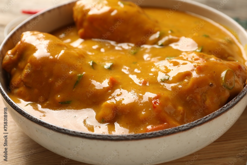 Tasty chicken curry on wooden board, closeup Tasty chicken curry on wooden board, closeup
