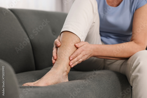 Arthritis symptoms. Woman suffering from pain in leg at home, closeup