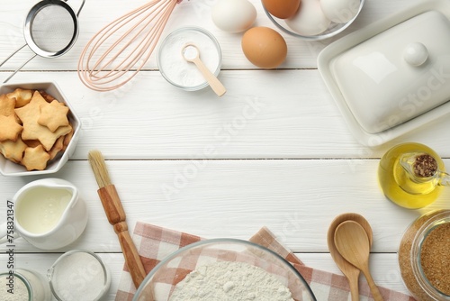 Frame of many different products on white wooden table, flat lay. Space for text