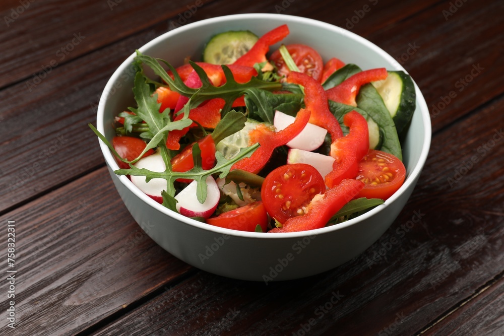 Tasty fresh vegetarian salad on dark wooden table
