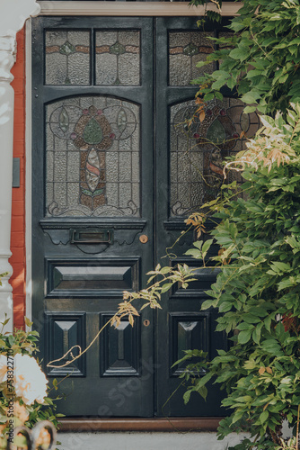 Dark grey stained glass door of an Edwardian house in London, UK.